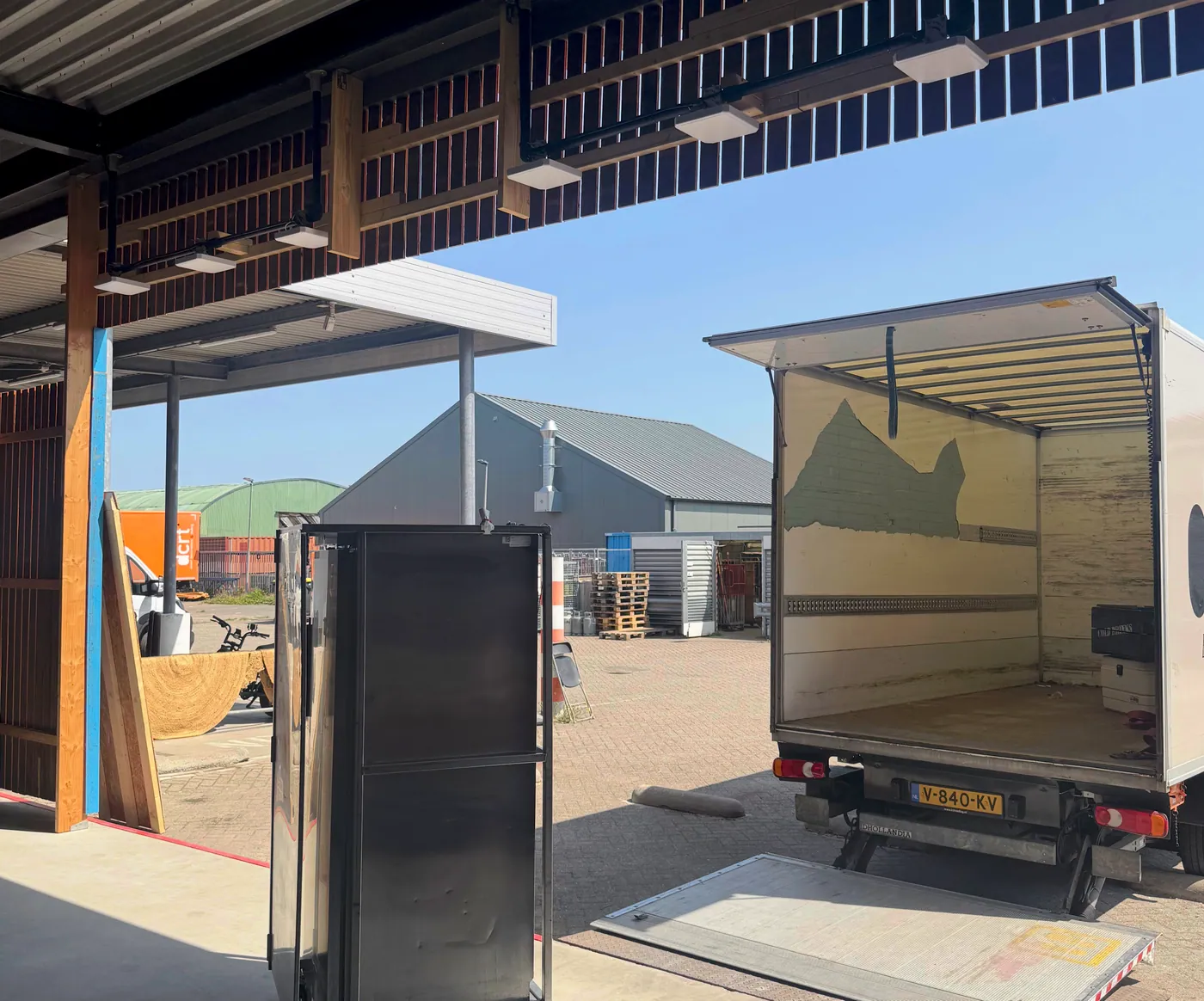 Rental returns arriving by truck at the warehouse loading dock